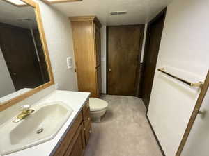 Bathroom featuring vanity and a textured wall
