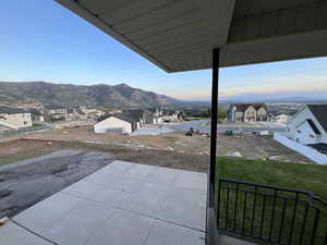 Patio terrace at dusk with a mountain view and a residential view