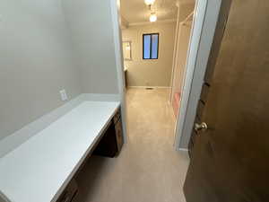 Bathroom with ornamental molding and a textured ceiling
