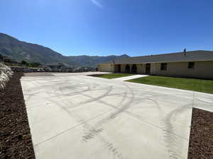 View of pool with a mountain view and a lawn
