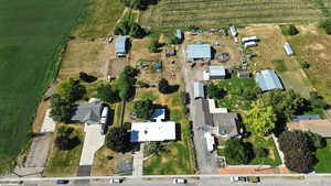 Aerial view of property and surrounding area featuring rural landscape and farmland
