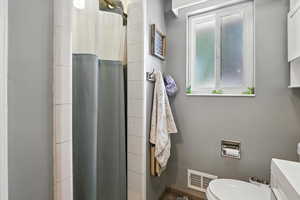 Full bathroom featuring vanity and curtained shower