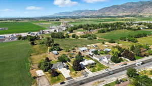 Aerial view of property and surrounding area with rural landscape and a mountain backdrop