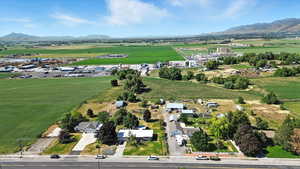 Aerial view of property's location featuring a mountainous background and rural landscape