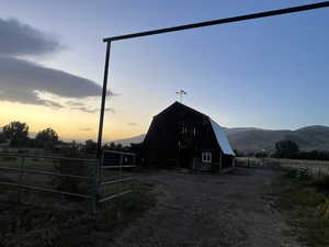 View of barn with a mountain view and a view of countryside