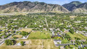 Aerial view of property and surrounding area featuring mountains