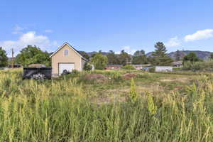 View of yard featuring a outbuilding garage and a mountain view