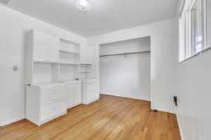 Unfurnished bedroom featuring light wood-style flooring and a closet
