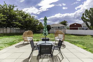 Fenced backyard with a patio area and outdoor dining area