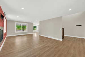 Unfurnished living room featuring light wood-style floors and recessed lighting
