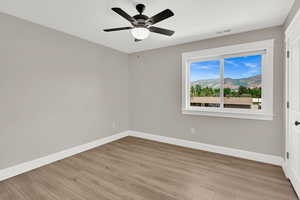 Spare room with light wood-style flooring and a ceiling fan