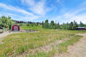 View of yard with an outbuilding, a barn, and a view of countryside