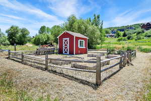 View of shed featuring a garden