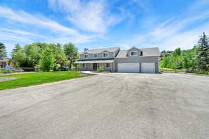View of front of property featuring driveway and a porch