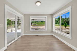 Empty room featuring light wood finished floors and ceiling fan