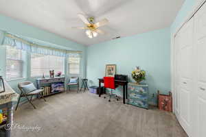 Office space featuring carpet floors and ceiling fan