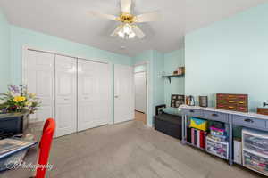 Playroom with carpet floors and a ceiling fan