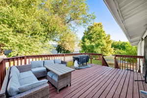 Deck with an outdoor hangout area and grilling area