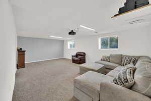 Carpeted living area featuring baseboards