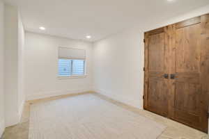 Unfurnished room with recessed lighting and baseboards