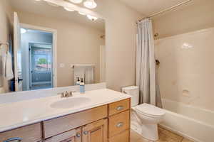 Bathroom with vanity, tile patterned floors, and shower / tub combo