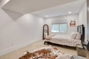 Bedroom with recessed lighting and concrete floors