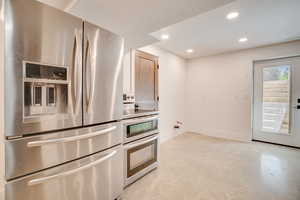 Kitchen featuring appliances with stainless steel finishes, recessed lighting, concrete floors, and a textured ceiling
