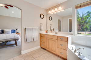 Bathroom with vanity, a ceiling fan, tile patterned floors, connected bathroom, and a bathtub