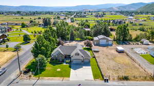 Aerial view of property and surrounding area featuring mountains