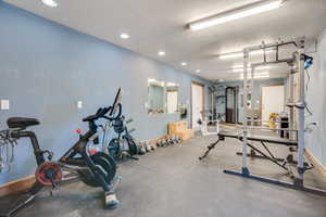 Gym featuring recessed lighting and a textured ceiling