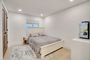Bedroom with recessed lighting and baseboards
