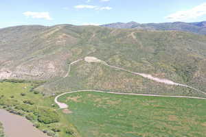 Aerial view of property and surrounding area with a mountain backdrop