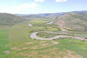 Aerial overview of property's location featuring a water and mountain view