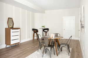 Dining area featuring light wood-type flooring and baseboards