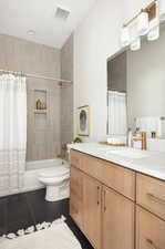 Bathroom featuring tile patterned floors, vanity, and shower / bath combo with shower curtain