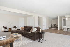 Living room featuring light wood finished floors and stairway