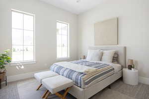 Bedroom with baseboards and carpet flooring