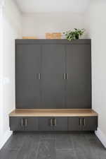 Mudroom with baseboards and dark tile patterned floors