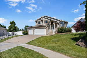 View of front facade featuring concrete driveway, a garage, and stucco siding