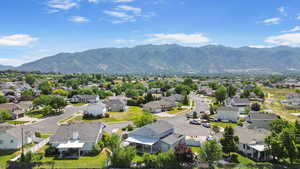 Aerial perspective of suburban area with a mountainous background