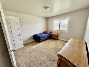 Carpeted bedroom featuring baseboards