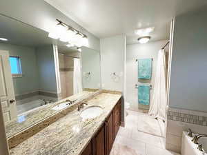 Bathroom featuring vanity, a garden tub, tile patterned flooring, and a shower with shower curtain