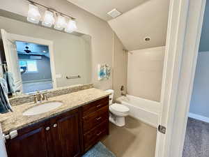 Bathroom featuring vanity, tub / shower combination, ceiling fan, tile patterned floors, and lofted ceiling