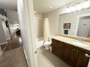 Bathroom with vanity and shower / tub combo with curtain