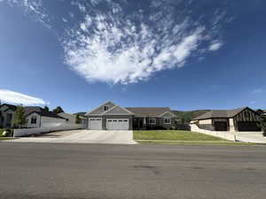 Craftsman-style house with a residential view, an attached garage, and driveway