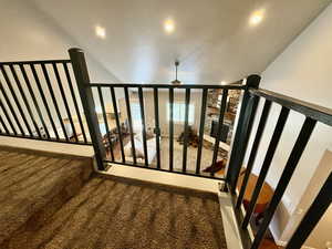 Stairway with carpet, recessed lighting, and a wall of windows