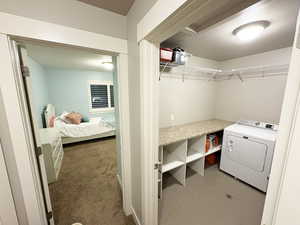 Laundry area featuring washer / dryer and carpet