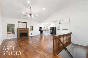 Living room featuring recessed lighting, a tile fireplace, dark wood-style floors, high vaulted ceiling, and a ceiling fan