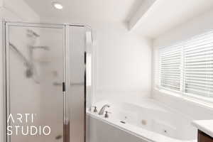 Primary bathroom featuring a shower stall, a whirlpool tub, vanity, and recessed lighting