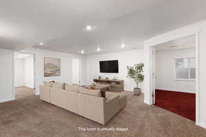 Virtually Staged - Living room featuring carpet, a textured ceiling, and recessed lighting